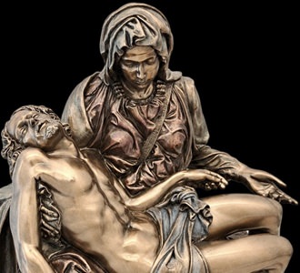 Pietà figur i bronzefinish på lys træhylde